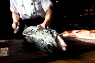 Midsection of man preparing food in commercial kitchen