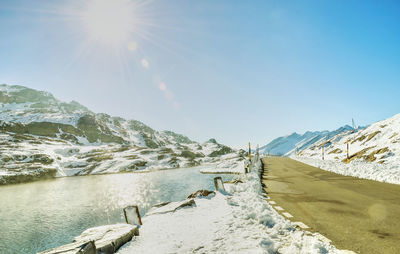 Scenic view of snowcapped mountains against sky on sunny day