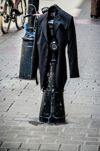 Low section of man standing on sidewalk