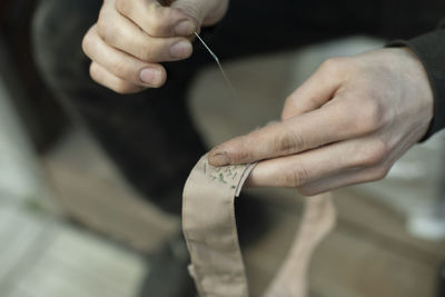 Sewing tape. collar stitching in army. work of weaver. repair clothes with your own hands.