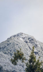 Low angle view of snowcapped mountain against clear sky