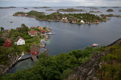 High angle view of townscape by sea against sky