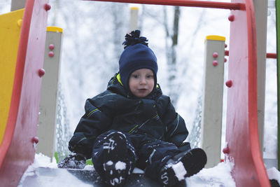 Portrait of girl sitting in snow