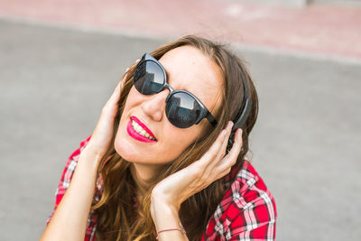 Close-up of woman listening music outdoors