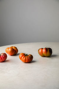 Ripening tomatoes on white table