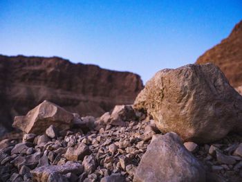 Rock formations against clear blue sky