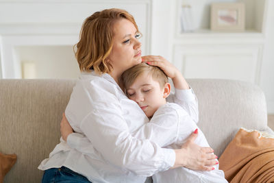 Side view of mother and daughter at home