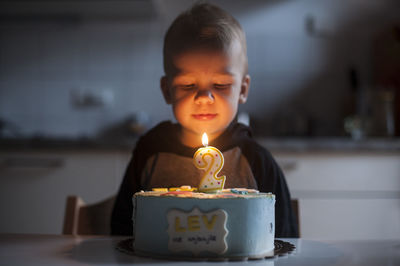 Close-up of woman holding illuminated candle