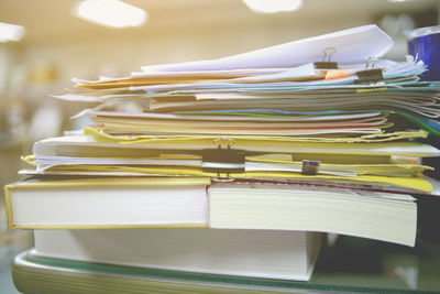 Close-up of files and books on table at office