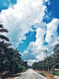 Empty road along trees and sky