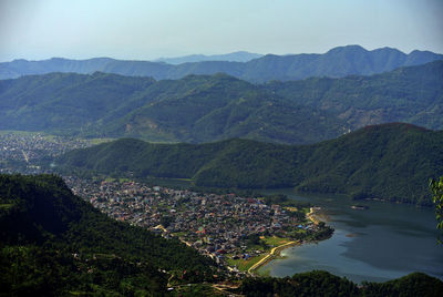 High angle view of townscape and mountains against sky