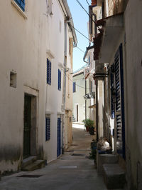 Empty alley amidst buildings in town