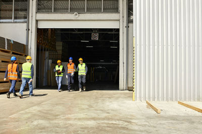 Group of workers walking on factory yard