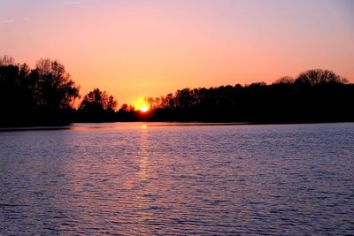 Scenic view of lake against sky during sunset