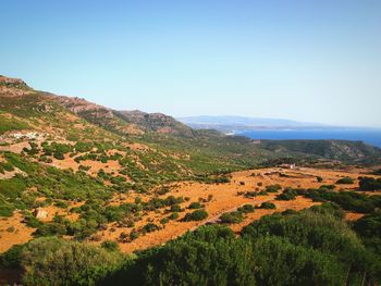 Countryside landscape against clear blue sky