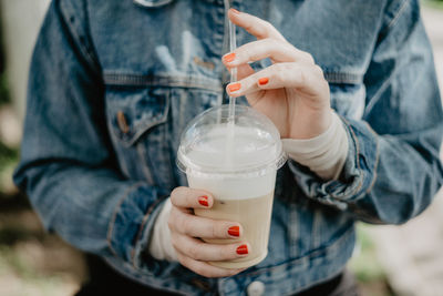 Midsection of woman holding drink