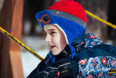 Boy playing outdoors during winter