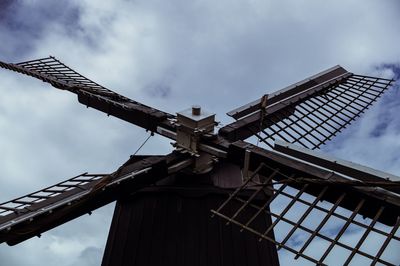 Low angle view of traditional windmill against sky
