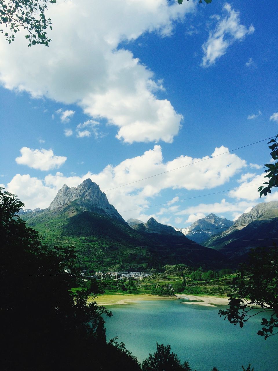 mountain, tranquil scene, mountain range, scenics, tranquility, sky, beauty in nature, water, lake, tree, cloud - sky, nature, cloud, landscape, idyllic, non-urban scene, river, day, outdoors, cloudy