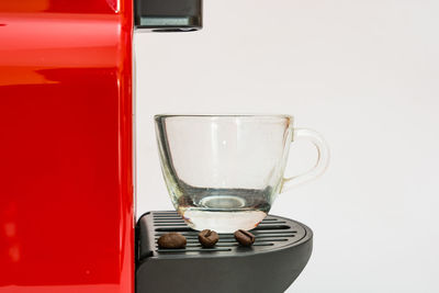 Close-up of wineglass on table against white background