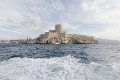 Castle by sea against sky