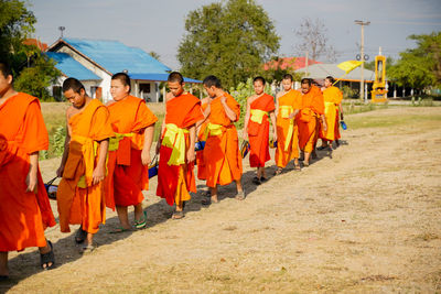 Group of people walking in row