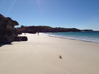 Scenic view of beach against clear sky