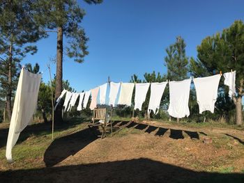 Clothes drying on clothesline against sky