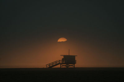 Moody sunset of lifeguard tower in venice beach, california