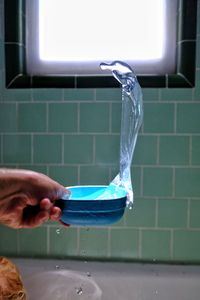 Close-up of person working in bathroom