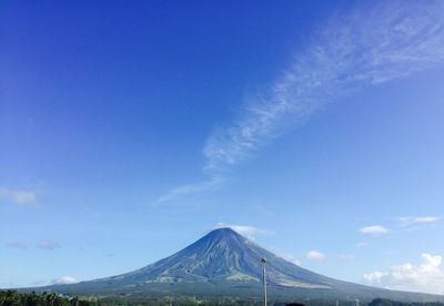 Scenic view of mountains against blue sky