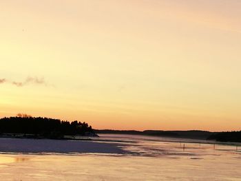 Scenic view of sea against sky at sunset