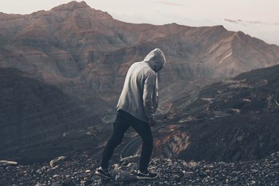 Full length of man standing on desert against mountains