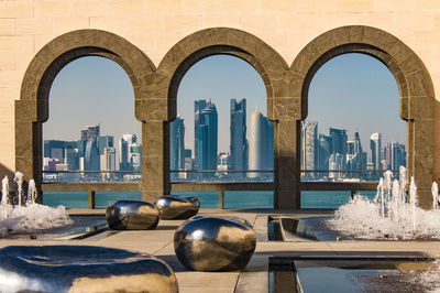 Buildings in city against clear sky