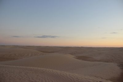 Scenic view of desert against sky during sunset