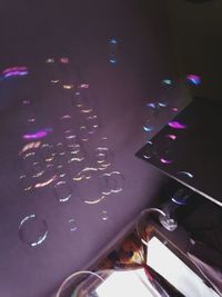 High angle view of illuminated wet metal