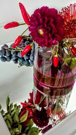 Close-up of red roses in glass vase on table