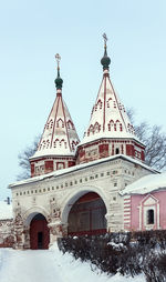 Low angle view of building against clear sky during winter