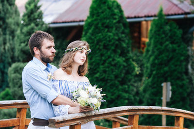 Couple kissing against plants