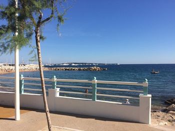 Scenic view of sea against clear blue sky