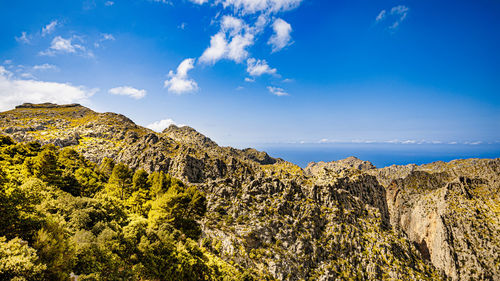 Scenic view of mountain against blue sky