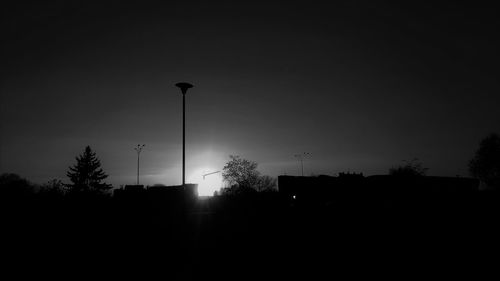 Low angle view of silhouette buildings against sky