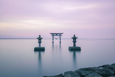 Scenic view of rocks in sea against sky