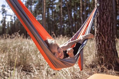 Portrait of girl lying on hammock