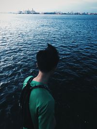 Rear view of woman standing in sea