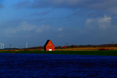 Building by sea against sky