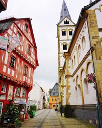 Street amidst buildings against sky