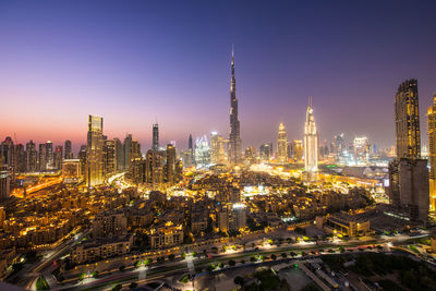 Illuminated cityscape against clear sky