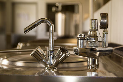 Close-up of faucet in kitchen at home