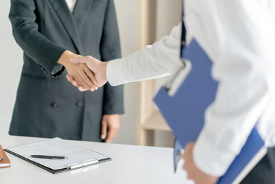 Midsection of couple standing on table
